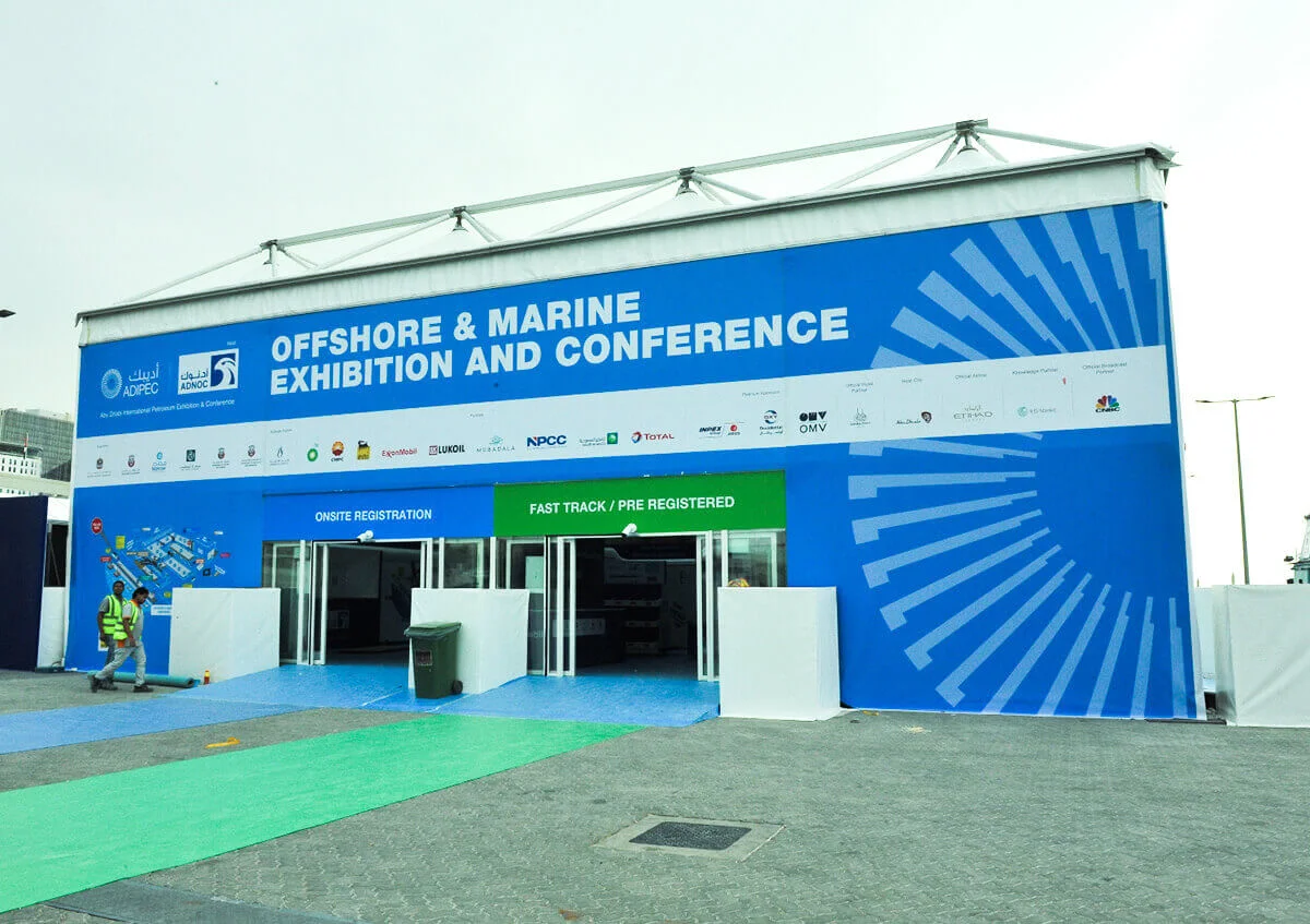 ADIPEC tent structures UAE - Royal tent exterior view with branding walls - ADIPEC - Alfares International Tents