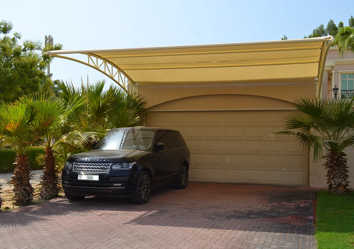 wall mounted parking shade UAE - car parked under durable wall mounted parking shade - Wall Mounted Parking Shade - Alfares International Tents