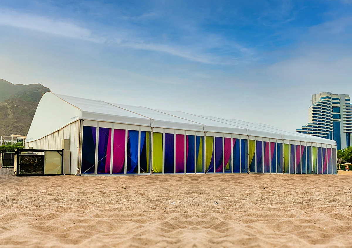 wedding marquee UAE - Vibrant wedding arch tent with colorful curtains in the glass panels - Wedding Marquee - Alfares International Tents