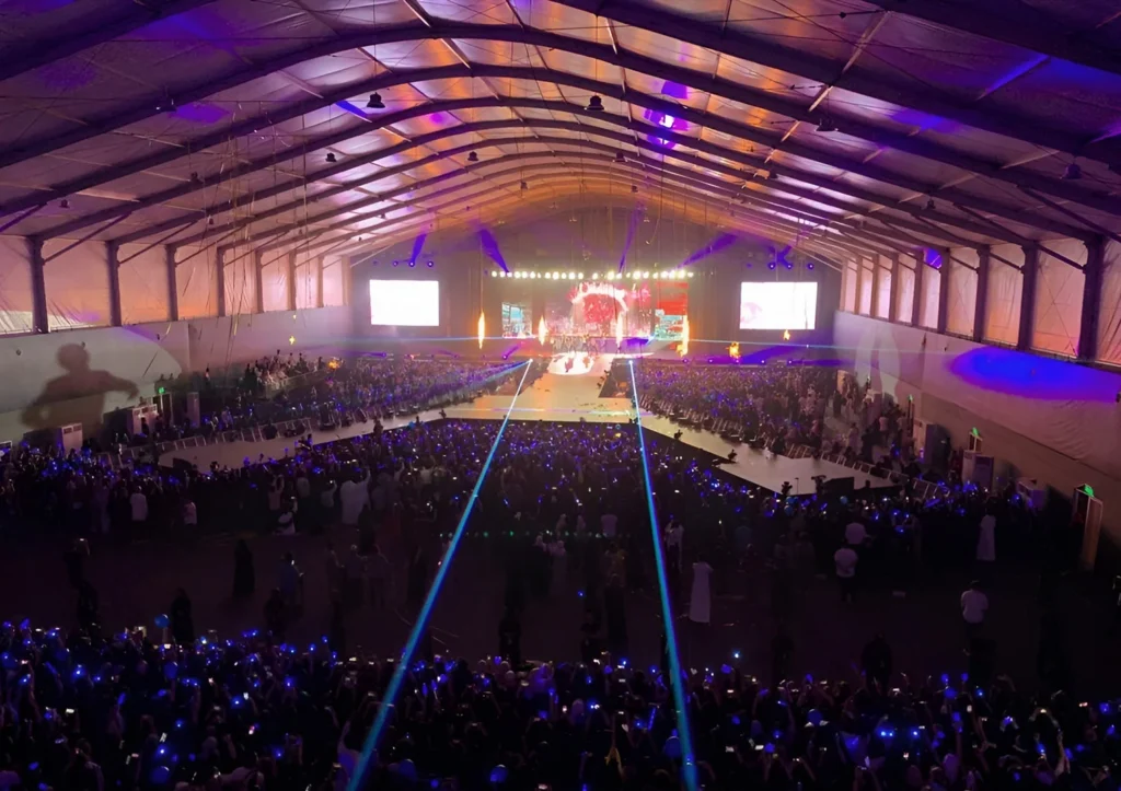 Concert Tents - Arch tent with a concert stage, lighting and a wide event space - How to Select the Ideal Concert Tent for Your Event - Alfares International Tents